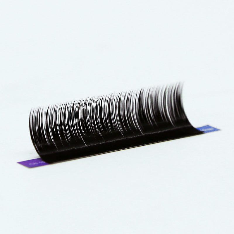 Individual eyelash extension fibers arranged along a pickup strip